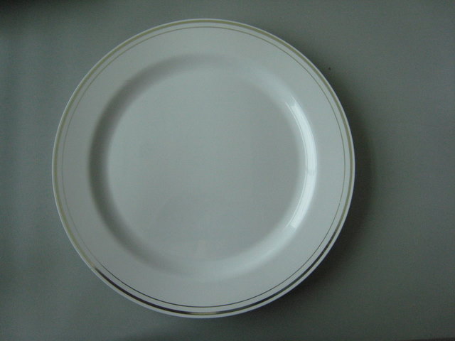 Round white plate with silver rim